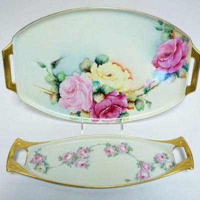 1028	HAND PAINTED PORCELAIN TRAYS EACH W/ROSES & GILT TRIM EDGES, BOTH SIGNED, LARGEST APPROXIMATELY 17 IN X 10 IN
