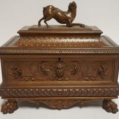 1058	OUTSTANDING CARVED DRESSER BOX WITH CARVED LIONS HEADS, PAW FEET AND CROUCHED DOG AT LID TOP, APPROXIMATELY 11 IN X 6 IN X 10 IN H
