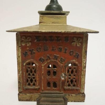 1053	ANTIUE MECHANICAL CAST IRON BANK, *HALLS EXCELSIOR BANK*, APPROXIMATELY 4 IN SQ X 5 1/2 IN H
