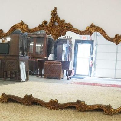 1176	HANGING MIRROR IN ORANTE CARVED GILT WOOD FRAME, APPROXIMATELY 69 IN X 47 IN H
