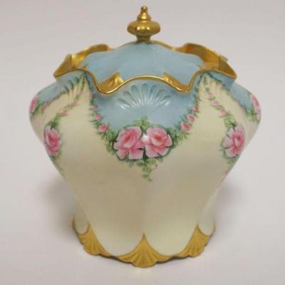 1012	HAND PAINTED PORCELAIN COVERED JAR, ROSES W/GILT TRIM ACCENTS, ARTIST SIGNED & DATED, APPROXIMATELY 7 IN HIGH
