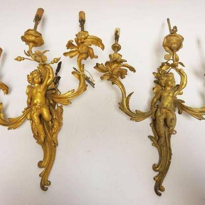 1195	PAIR OF BRONZE CHERUB WALL SCONCES, EACH APPROXIMATELY 22 IN H. SOME LOSS TO APPLIED LEAVES
