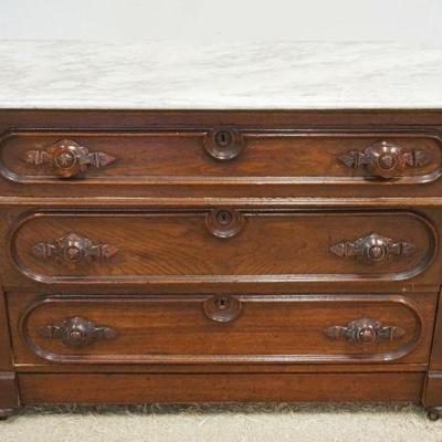 1152	ANTIQUE VICTORIAN MARBLE TOP 3 DRAWER CHEST WITH CARVED DRAWER PULLS, APPROXIMATELY 47 IN X 22 IN X 33 IN H, SOME LOSS TO BACK
