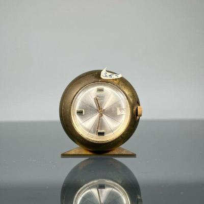 PHIGIED EXTRA DESK CLOCK | Heavy and of small size, of spherical shape, on a triangular base. - h. 1.75 x d. 1.5 in

