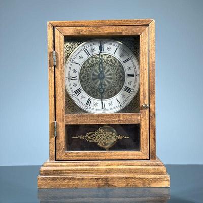 OAK CASE SHELF CLOCK | The oak case with front windowed door with applied decoration to lower section, the enameled metal face with Roman...