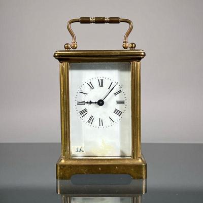 FRENCH BRASS CARRIAGE CLOCK | Brass cased carriage clock having five beveled glass panel, unmarked face with Roman numeral markers, the...