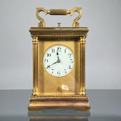 HEAVY BRASS CARRIAGE CLOCK | Likely French, heavy, having a brass case with five beveled glass panels, white porcelain face with Arabic...