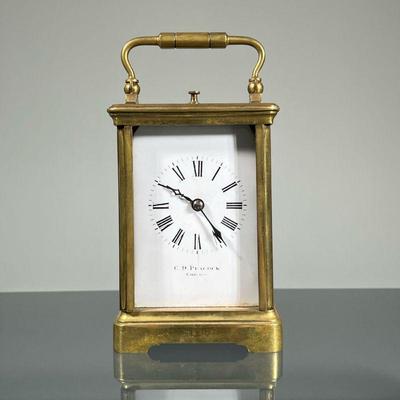 C. D. PEACOCK CARRIAGE CLOCK | A C. D. Peacock, Chicago carriage clock frame / movement, lacking glass panels except on the top, the face...