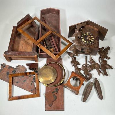 MISC CLOCK PARTS | Including: box w/ large cuckoo clock with many parts/pieces, some wood carved accents disconnected but present, and...