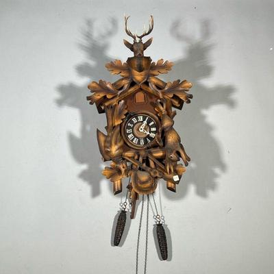 BLACK FOREST STYLE CARVED WOOD CLOCK | With carved game decoration and wood pendulum, separate stag's head mount, having two pine...