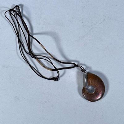 STERLING & FOSSILIZED AMMONITE PENDANT | Sterling silver and fossilized ammonite pendant on corded necklace, pendant marked...
