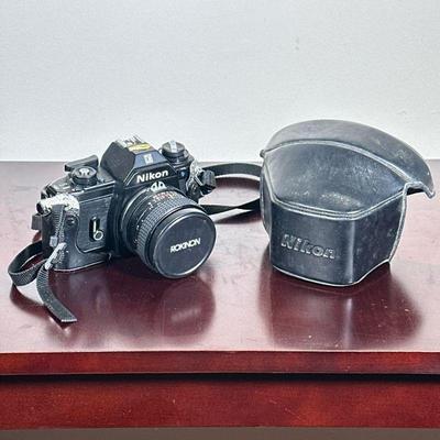NIKON EM SLR CAMERA | Nikon EM SLR film camera with Rokinon Auto SC lens and leather case. - h. 4 x w. 4.5 x l. 6 in


