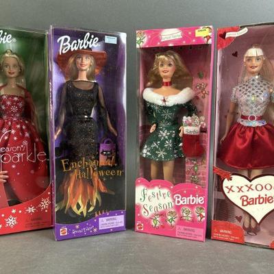 Lot 187 | Four NIB Seasonal Barbie
