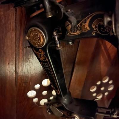Old sewing machine in cabinet 
