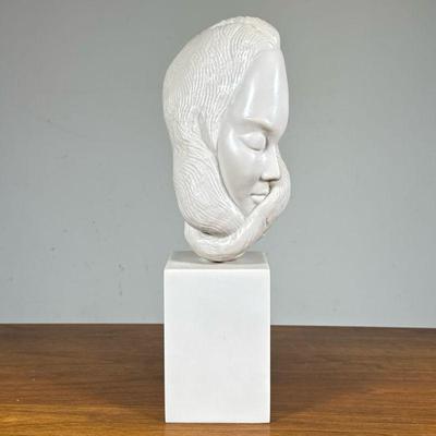 COMPOSITION SCULPTURE of a WOMAN | Resin or other, showing the face of a lady with sinuous hair, no apparent signature or identifying...