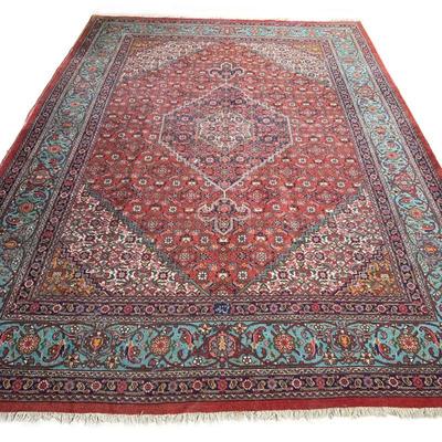 EARLY 20th CENTURY PERSIAN KASHAN CARPET | Central medallion on a red ground within blue and red borders. - w. 105 x l. 145 in