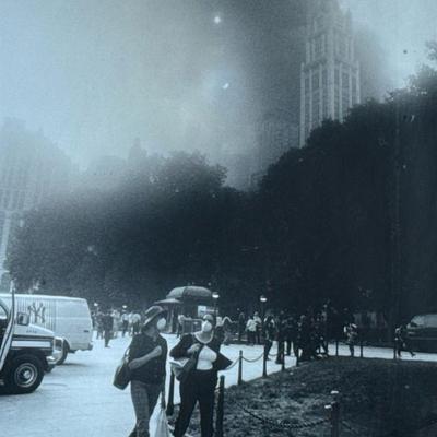 FRANK RITTER (American, 1946-2023) PHOTOGRAPH | September 11, 2011. Women walking before the dust cloud of the towers. h. 19.5 x 15 in.,...