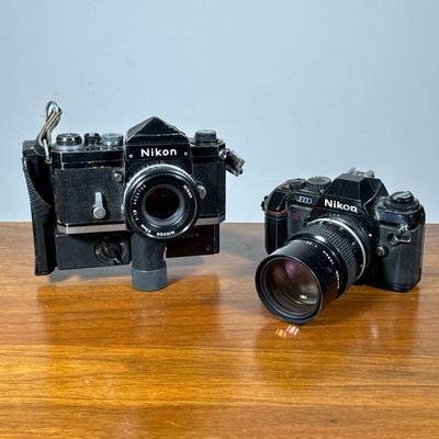 (2pc) Nikon 35mm Cameras | Nikon SLR film cameras including a Nikon N2000 and a Nikon on a Polaroid proback by forscher.

