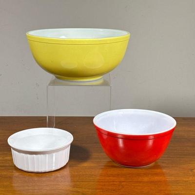 (3pc) Vintage Pyrex Bowls | Including Pyrex red and yellow mixing bowls, smaller dia. 7.25 in, and a Corning Ware ramekin. - h. 4.5 x...