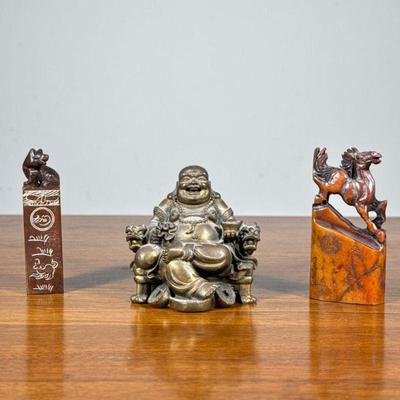 (3pc) Chinese Stamps & Buddha | Including a brass figure depicting Buddha sitting in a dragon armchair, and two carved stone seal...