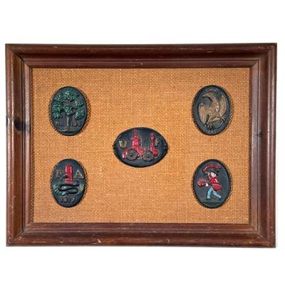 Framed Metal Plaques | Cold painted plaques on a woven jute backing in a wood frame, including an "FA" plaque dated 1817 and an...