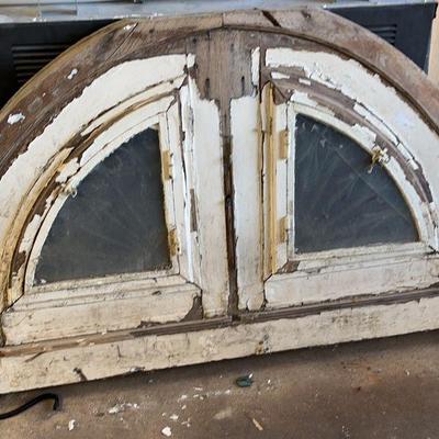 Vintage arched  double glass window opening up to metal grates