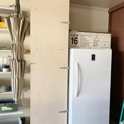 Storage cabinet with shelves 8 feet tall and Insignia upright Freezer, Model NSUZ14XWH7
