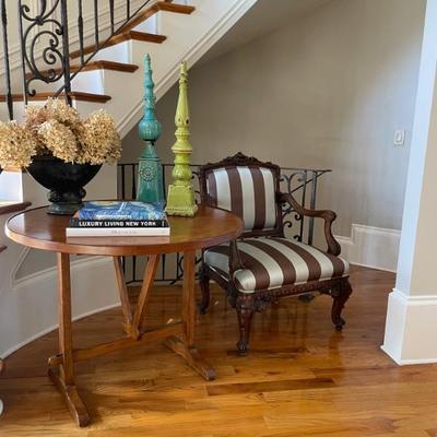 An Antique French Pine Wine Table, 19th c., the circular hinged top on a trestle form base, height 29 in., diameter 42 1/2 in.