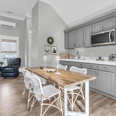BUTCHER BLOCK WITH METAL TRUSSES LONG TABLE AND WHITE WOVEN WITH METAL TRUSSES SIDE CHAIRS