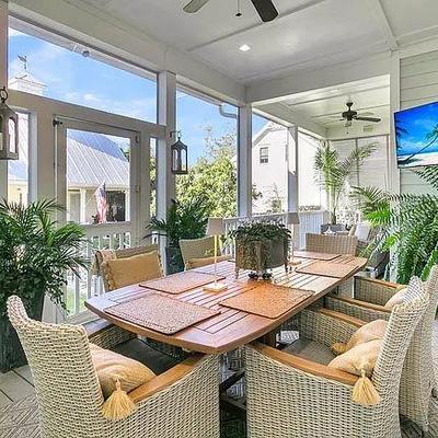 ROYAL TEAK BUTTERFLY LEAF TEAK LONG BOAT SHAPED DINING TABLE AND 6 MATCHING CREAM WICKER WITH TEAK ACCENTS ARMCHAIRS