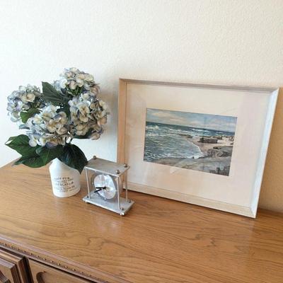 Lot #44 - Home Décor Lot - Framed Beach Painting, Metallic Clock, and Floral Arrangement.