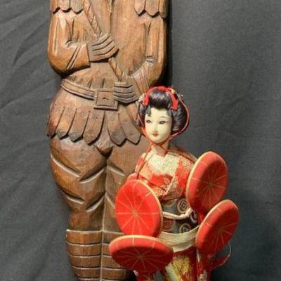 Carved wooden wall hanging and asian doll