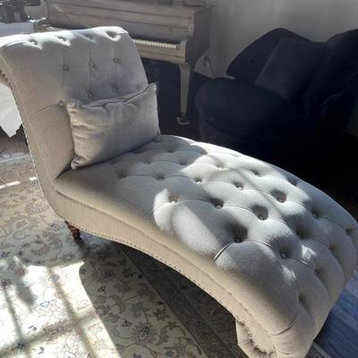 Antique Victorian tufted chaise lounge covered in beige linen