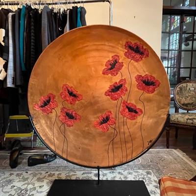 Large painted and enameled metal disc, decorated with poppies on stand by Lisa Steinkamp