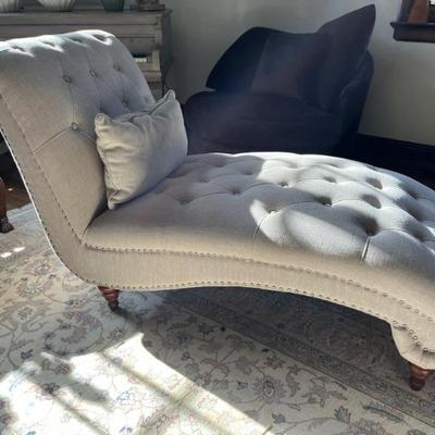 Antique Victorian tufted chaise lounge covered in beige linen
