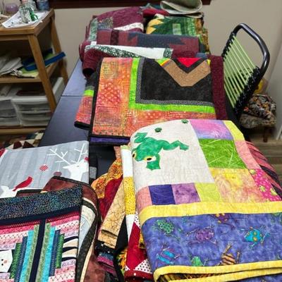 A room full of quilting supplies, fabrics, tools, finished quilted items and more!!
