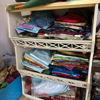 A room full of quilting supplies, fabrics, tools, finished quilted items and more!!