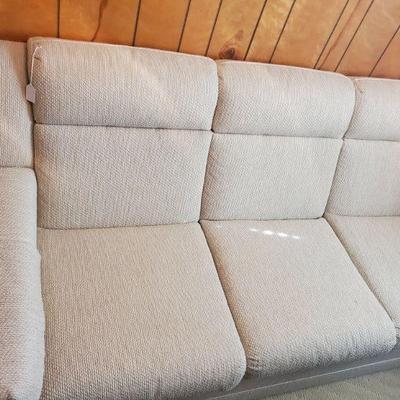 Comfortable and study three-seater sofa upholstery in neutral beige fabric