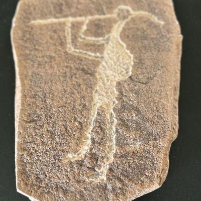 Primitive man holding spear etched in stone