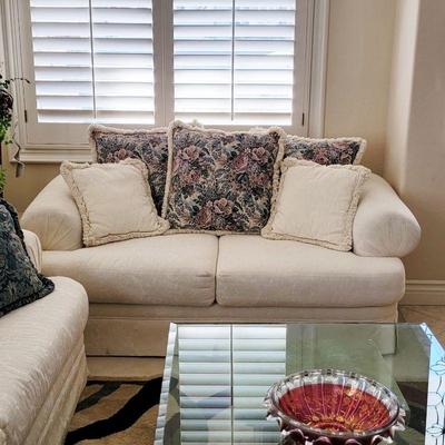 Comfy sofa, glass top table, cranberry art glass bowl