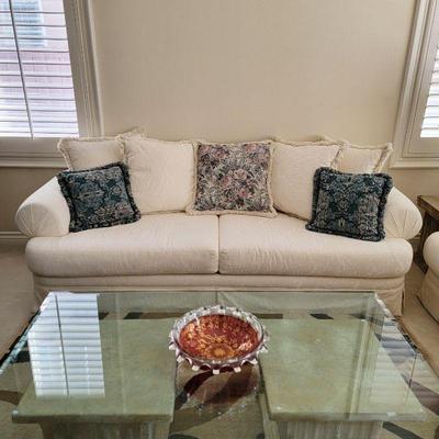 Comfy love seat, glass top table, cranberry art glass bowl