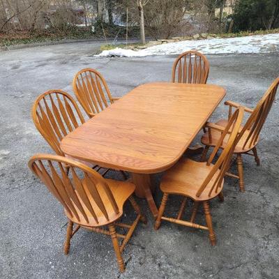 Solid oak table and chairs.  65" X 41" without leaves. 2 leaves included are 18" ea. $160