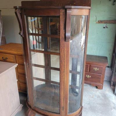 Curved glass curio. Solid oak. 35" w X 65" tall. $90