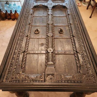 Carved table from India. Can be converted from a dining table to a coffee table by using the shorter legs which are included.  Glass top...