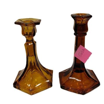 TWO AMBER GLASS CANDLE HOLDERS