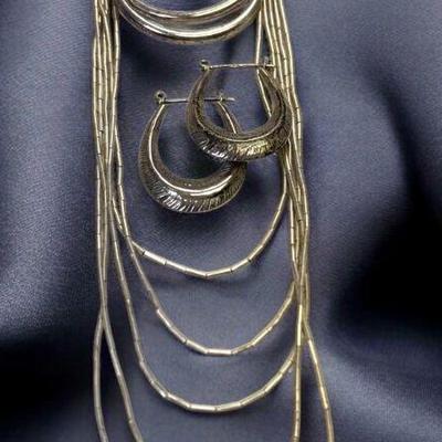 Liquid silver multi strand necklace complementing earrings