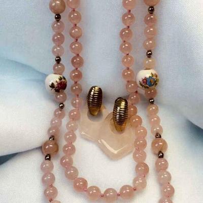 Pink jadeite bead strands complementing earrings