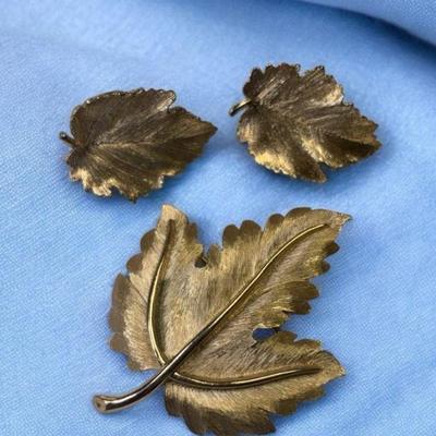 Trifari brooch complementing clip earrings
