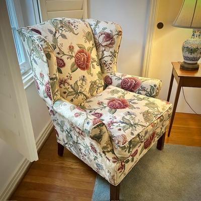 Second of two floral custom-upholstered wingback chairs