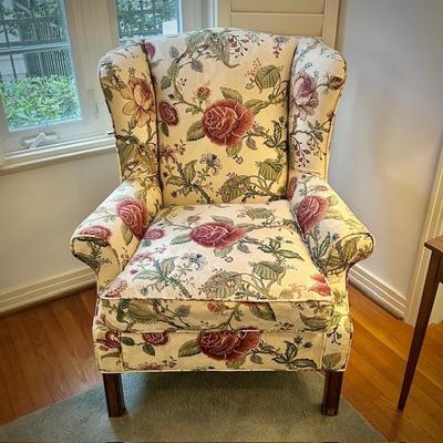 One of two floral custom-upholstered wingback chairs